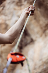 Hand holding a rock climbing rope
