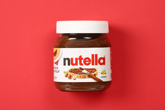 Nutella jar on a red background, top view, flat lay	