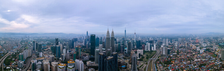 Naklejka na ściany i meble High angle view of sunrise at Kuala Lumpur city skyline with Petronas Twin Towers from Traders Hotel