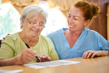 Nurse helps senior citizen solve the puzzle