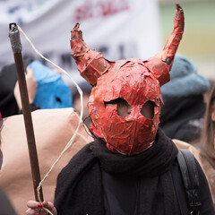 person wearing a devil mask