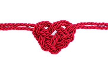 Heartbeat shape made from threaded cord on white
