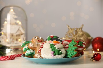 Sweet Christmas cookies and festive decor on white table