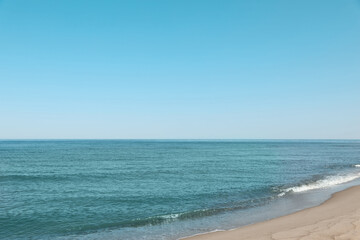 Fototapeta na wymiar Beautiful view of sea shore under blue sky on sunny day