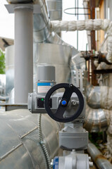 Gate valve with electronic control, on the heating plant, close-up. Industrial heating system