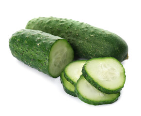 Whole and cut cucumbers on white background
