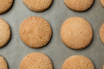 Delicious sugar cookies on parchment paper, flat lay