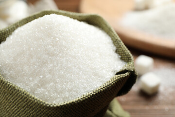 Granulated sugar in sack on table, closeup