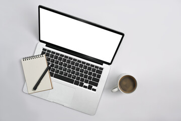 Top view laptop computer, notepad, coffee cup and succulent plant on office desk