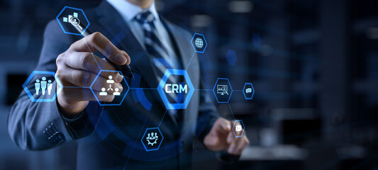 CRM Customer relationship management concept. Businessman pressing button on screen.