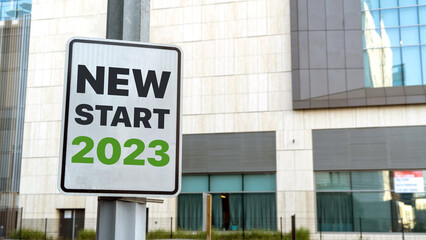 New start 2023 sign in a downtown city setting	
