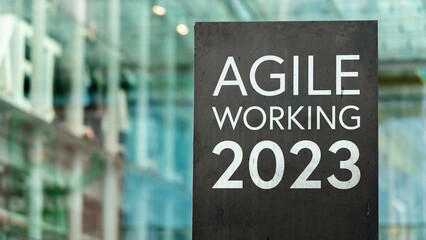 Agile Working 2023 sign in front of a modern office building	
