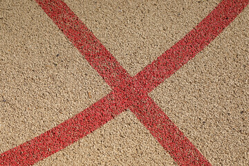red cross on a cork beige court floor, 
sport court background with space for text and no person