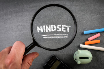 Mindset. Office supplies and colored pieces of chalk on a dark blackboard