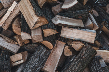 Wooden natural sawn logs as background, top view, flat lay. Wood texture. Firewood stack.