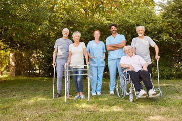 Group of seniors in the garden of the nursing home with male nurse