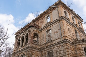 Historic old Early 20th century brick ruined derelict abandoned house villa building facade