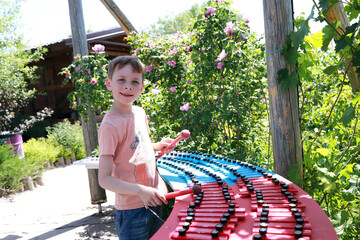 Child playing xylophone in park