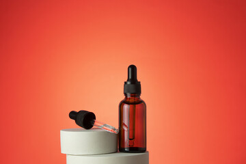 Beauty collagen face serum in a glass dropper bottle on podium. Face and body care spa concept and natural cosmetics