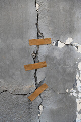 Cracked concrete wall with adhesives
