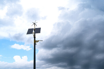 pole with solar panel and wind direction