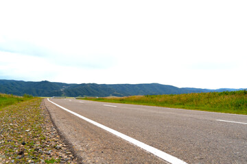 empty road against the backdrop of mountains.