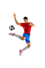 Fototapeta na wymiar Portrait of young man, football player in motion, training, kicking ball in a jump isolated over white studio background
