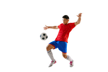 Fototapeta na wymiar Portrait of young man, football player training, playing, kicking ball isolated over white studio background