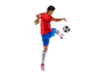 Fototapeta na wymiar Dynamic portrait of young man, football player in motion, kicking ball isolated over white studio background. Forward position