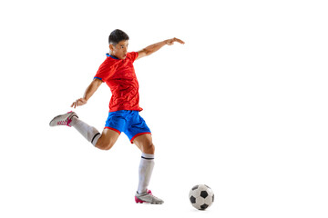 Portrait of young man, professional football player in motion, training, dribbling ball isolated...