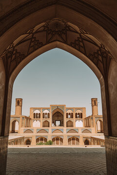 Arched passage against ancient mosque