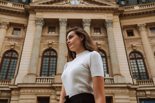Calm young woman sightseeing in old city district