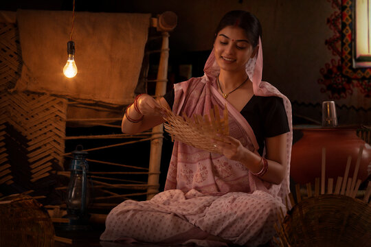 Portrait of woman making wicker mat at home