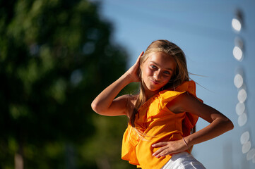 Joyful girl standing looking at camera on street