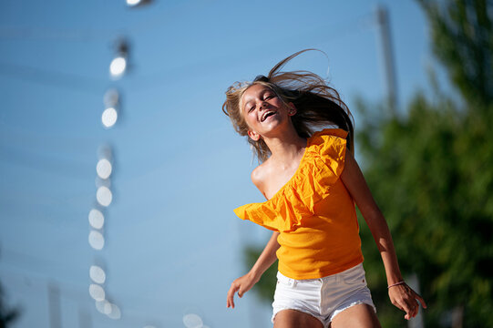 Joyful Girl Jumping On Street