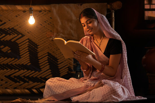 Portrait of a woman reading book at home