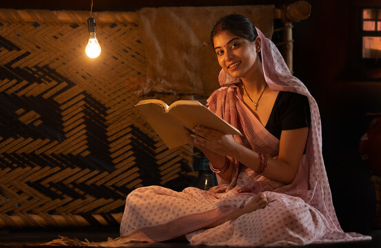 Portrait of a woman reading book at home