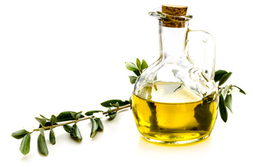 Olive oil in a bottle with a twig from an olive tree isolated on white background