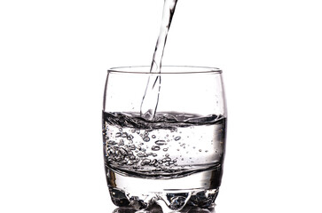 Pouring fresh water in a glass isolated on white background