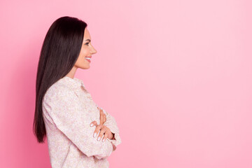 Profile photo of young attractive pretty woman smiling wear shirt folded arms looking empty space isolated on pink color background