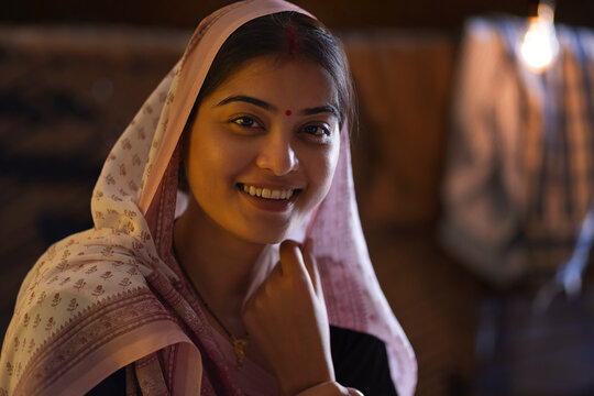 Close-up portrait of smiling Bihar woman at home