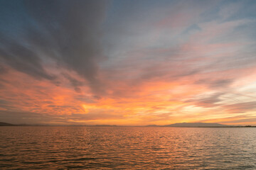 Sunset over the sea with cloudy and colorful beatiful sky view.