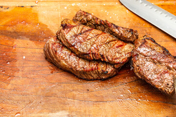 steaks stacked up on a cutting board