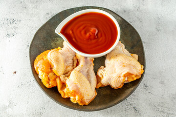 chicken drumstick and sauce, top view