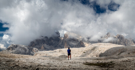 High mountain panorama with a standing explorer in the middle