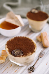 Tiramisu in the glass on the wooden