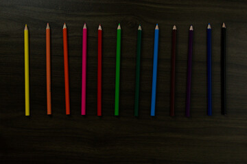 Colored pencils on blue background. with copy spacing