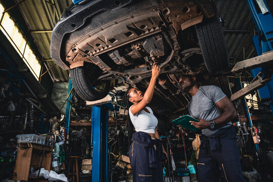 Professional mechanics are checking the car is suspension problems thoroughly.