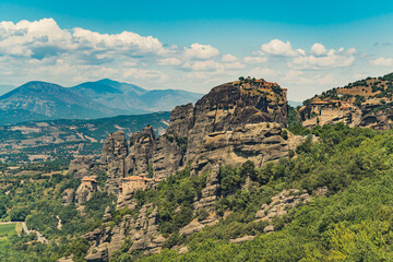 Religious place to visit during holidays in Greece. Famous Meteora monasteries seen from afar. Drone shot. . High quality photo