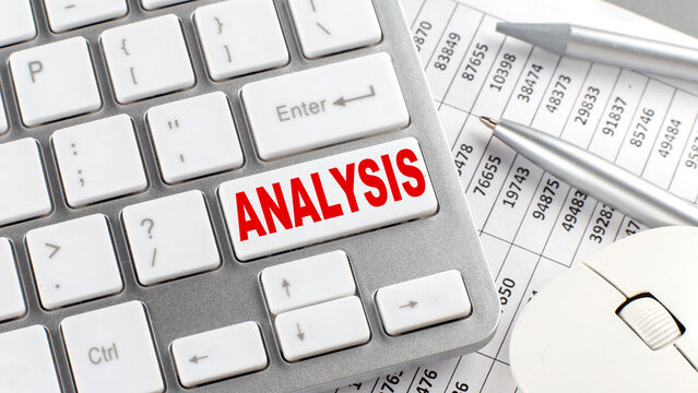 ANALYSIS text on a keyboard wirh chart and pencil